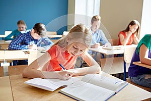 Student girl with book writing school test