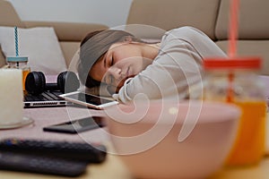 Student girl with books and coffee sleeping on the table