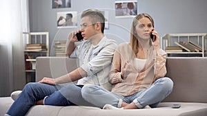 Student girl and boy talking on phones on sofa, imagining they sitting together