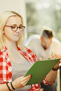 Student girl in front of her mates in classroom