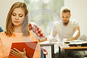 Student girl in front of her mates in classroom