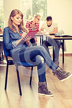 Student girl in front of her mates in classroom