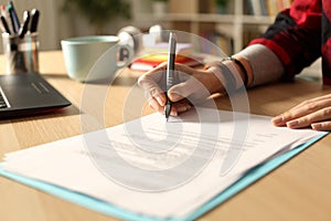 Student girl hand signing contract at night