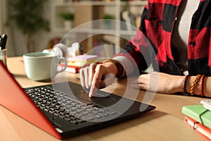Student girl hand using laptop in the night at home