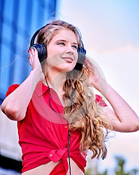 Student girl in headphone listen music