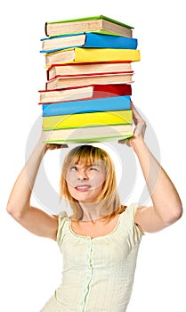 Student girl holding stack color books over the head. Isolated