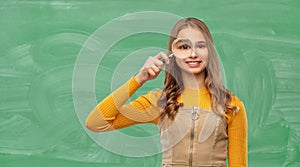 Student girl looking through magnifier at school