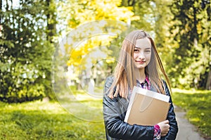 Student girl outdoors going back to school and smiling