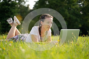 Student girl person work on tablet, computer in summer park. Online woman in nature outside. Laptop outdoor business