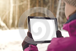 Student girl reading e-book on the bench in park. Digital tablet computer with blank isolated screen. Education background.