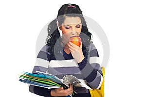 Student girl reading and eating apple