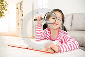 Student girl reading with magnifying glass