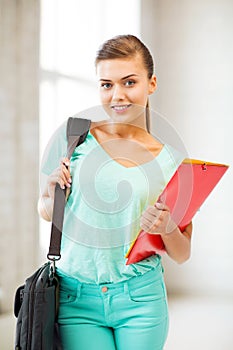Student girl with school bag and color folders