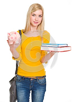 Student girl showing books and piggy bank