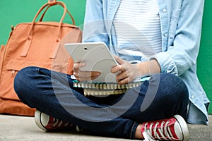 Student girl sitting and using digital tablet, online education, adult learning concept