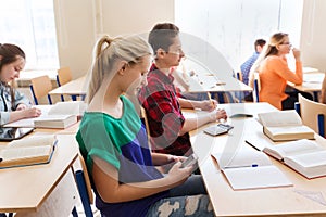 Student girl with smartphone texting at school