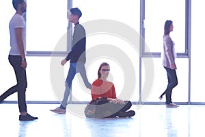 Student girl standing with laptop, people group passing by