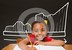 Student girl at table against grey blackboard with school and education graphic