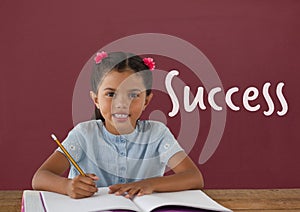 Student girl at table against red blackboard with success text