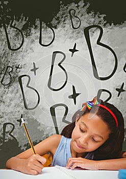 Student girl at table writing against green blackboard with school and education graphic