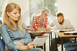 Student girl with tablet in front of her classmates