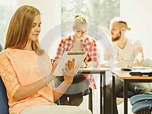 Student girl with tablet in front of her classmates