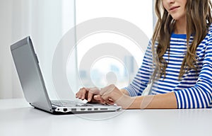 Student girl typing on laptop computer