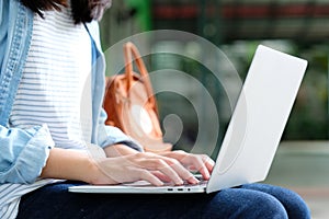 Student girl using laptop computer, online education, adult lea