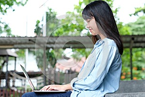 Student girl using laptop computer, online education,  adult learning concept