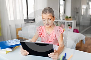 Student girl using tablet computer at home