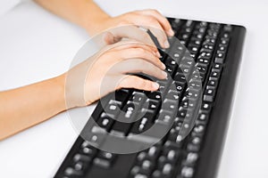 Student girls hands typing on keyboard