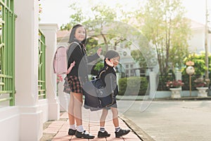 Student going to school and waving goodbye