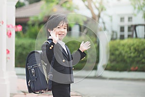 Student going to school and waving goodbye