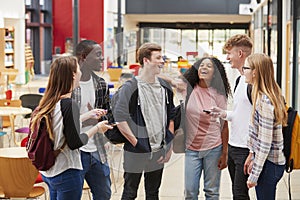 Student Group Socializing In Communal Area Of Busy College