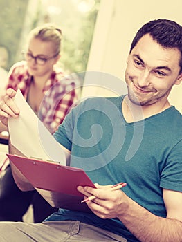 Student guy in front of her mates in classroom