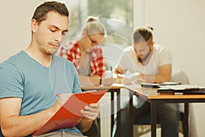 Student guy in front of her mates in classroom