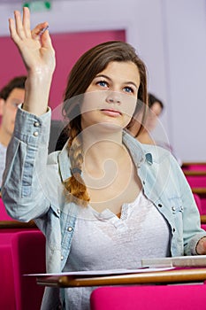 student hands up answer question in class