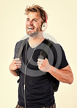 Student handsome guy listening music. Modern people concept. Man tousled hairstyle wear plastic earphones gadget. Enjoy