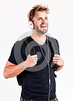 Student handsome guy listening music. Modern people concept. Man tousled hairstyle wear plastic earphones gadget. Enjoy