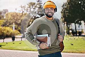 Student, headphones and backpack on campus of education, college or university podcast in park. Portrait of african man