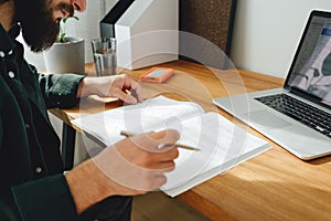 Student hipster doing home work while studying at university