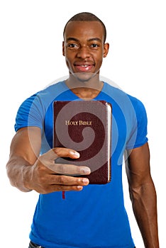 Student holding a bible showing commitment