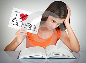 Student holding a sign with the words I hate school