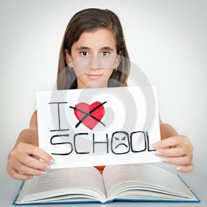 Student holding a sign with the words I hate school