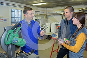 Student in ironworks class using circular saw