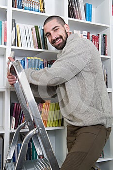 Student on Ladder in Library