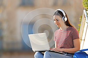 Student with laptop and headphones elearning photo