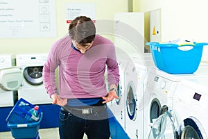 Student in a laundry with shrunk pullover