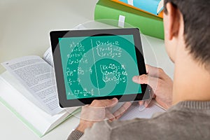 Student Learning Mathematical Equations On Digital Tablet photo