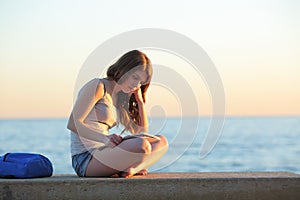 Student learning memorizing notes on the beach photo